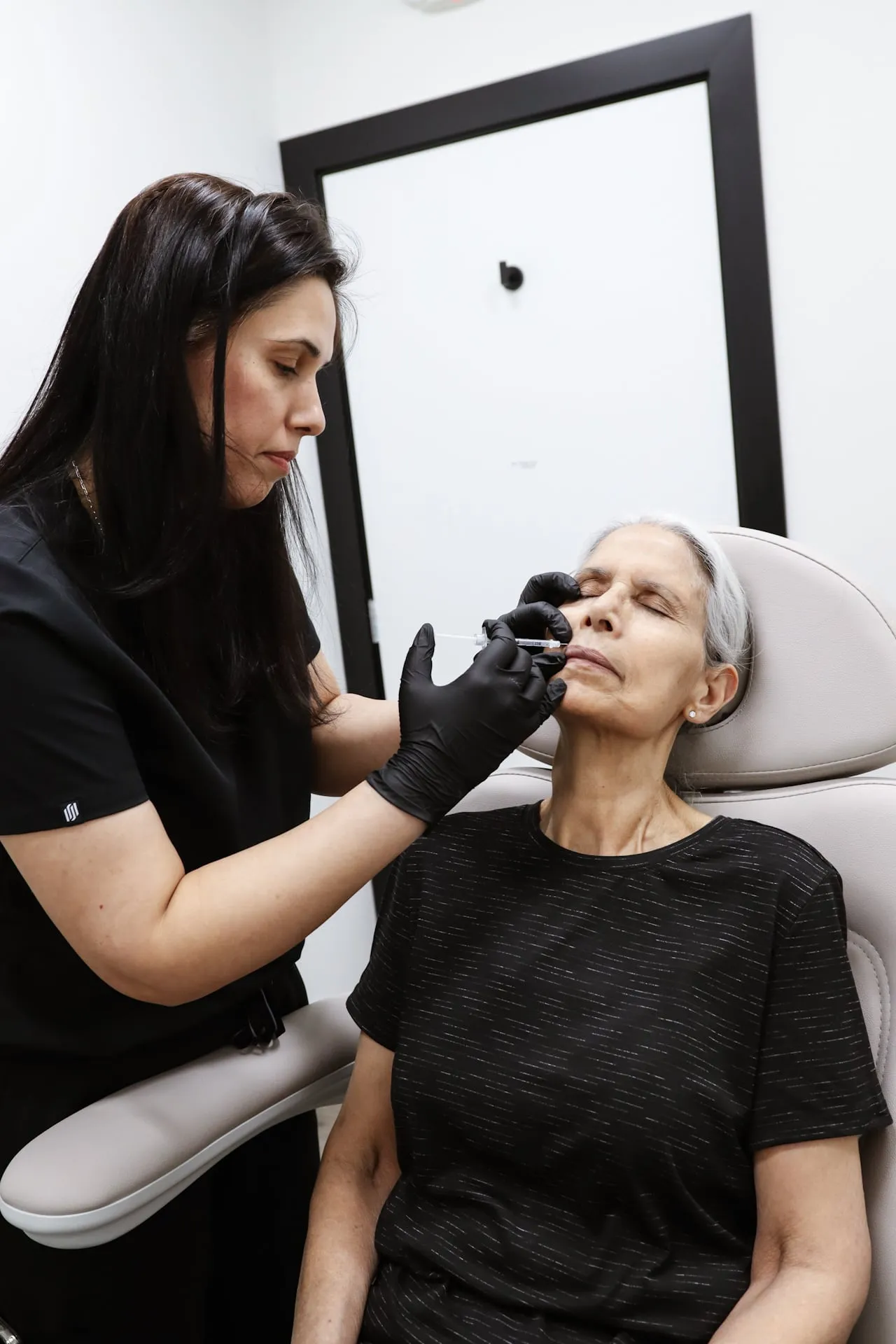 A mature patient receives an injectable wrinkle treatment at the clinic