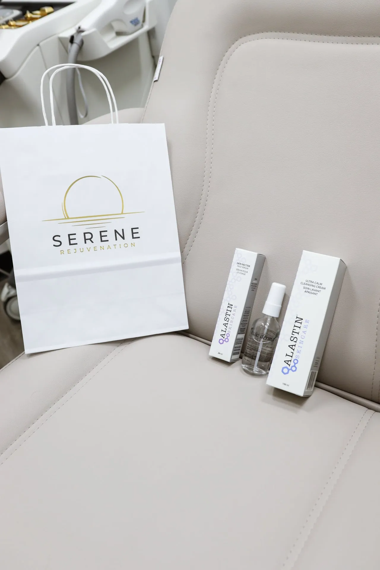 A Serene Rejuvenation gift bag beside boxed Alastin skincare products